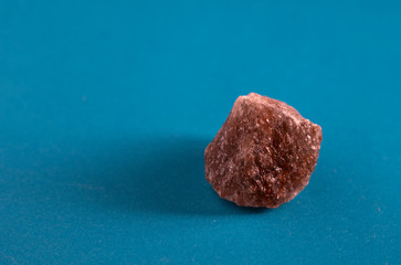 Alpine pink salt from Austria on a blue background
