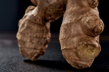 Naklejka premium macro photo. ginger root on a black background. side view. volume ripe product. macro photo. Against viruses and diseases.