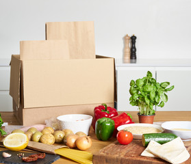 Box with packed meat vegetables on kitchen background. Food delivery services during coronavirus pandemic and social distancing. Shopping online. .Dinner delivery service.