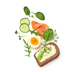 Open sandwich salmon, cucumber, boiled egg, soft cheese flying. Homemade sandwich with rye bread isolated on white background. Levitation fly salmon smorrebrod creative cook concept