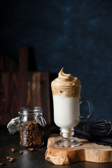 The Korean coffee drink dalgona on dark wooden background