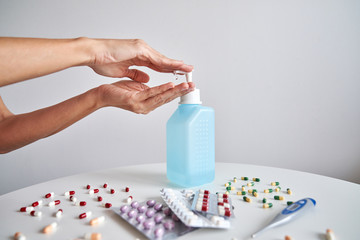 Woman cleaning her hands with alcohol antiseptic gel to prevent infection