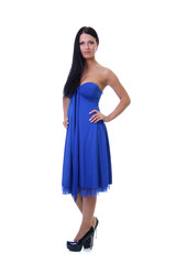 Portrait of a young beautiful brunette woman in blue dress