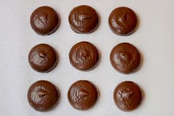 marshmallows in chocolate, sweets on a background with a mug of coffee