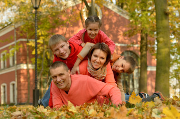 Fototapeta premium Portrait of family relaxing in autumn park
