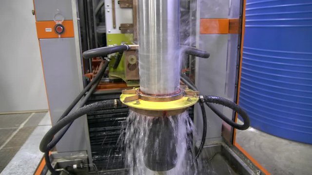 Metal induction hardening machine. Process of quenching metal with a high frequency current. Hardening of the steel shaft.