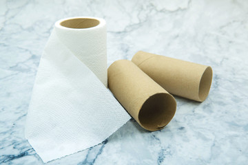 Toilet paper roll and paper tubes on background. Corona virus outbreak situation. Stock  toilet paper for self quarantine at home prevention COVID-19.