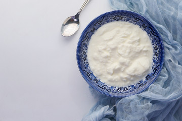 Close up of greek yogurt in a bowl on table 