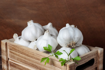 garlic heads in a wooden box on wood background