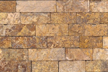 Rust-colored sandstone wall. Natural, rustic style construction.