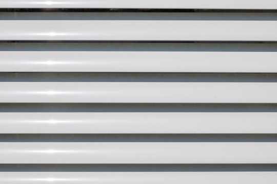 some white slats of a blind form a background