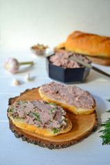 Home made pate of beans and walnuts on a wooden background.