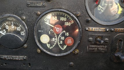 Aviation indicator of oil temperature and oil pressure and fuel pressure on the black panel of an old an2 airplane with arrows