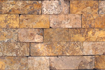 Rust-colored sandstone wall. Natural, rustic style construction.