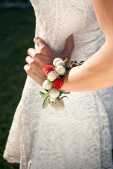 A lady's arm holding her wrist bouquet