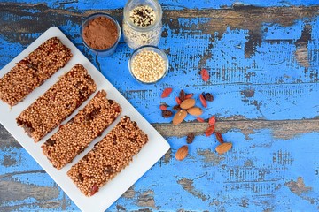 Healthy breakfast bars with puffed quinoa, cocoa powder, almond butter, goji berry, raisin, maple syrup and coconut butter