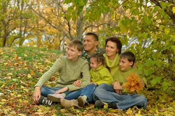 Fototapeta premium Portrait of family relaxing in autumn park