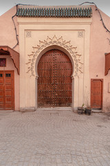 Old carved wooden door with decorative studs, Marrakech, Morocco