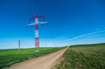 Electric pole in the center of the beautiful green fields