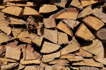 texture of pine firewood. Chipped firewood is on the heap. Woodpile of firewood close-up. A stack...
