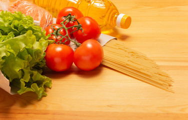 Food delivery service. Healthy food on wooden table. Buy online during quarantine. Tomatos, pasta, sunflower oil, salad. High quality photo. Stay home, be safe.