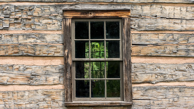 Window in an old wooden house of the times of american exploration