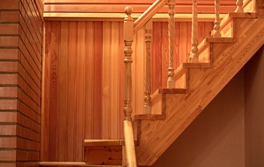 Fototapeta premium Wooden staircase from the hall to the second floor