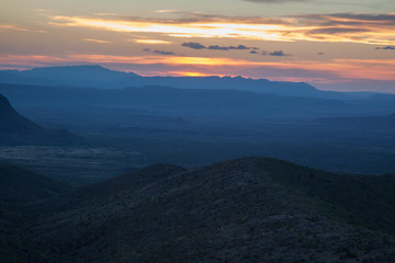 Naklejka na ściany i meble Sunset in the desert with mountains