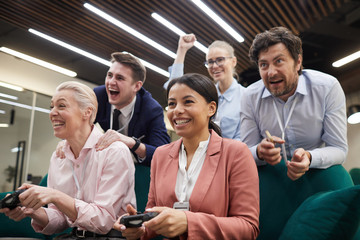 Group of business people playing in video game together during their break at office © AnnaStills
