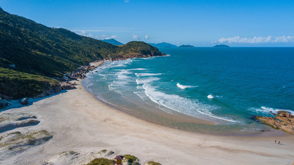 Deserted beach behind the mountain in Guarda do Embaú. Beautiful beach among green mountains in Santa Catarina, Brazil