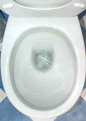 Cotton swabs thrown in a toilet of a home. Concept of bad habits for the environment, pollution,...