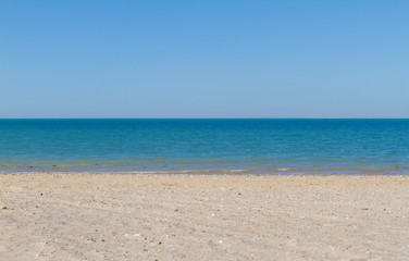 Fototapeta na wymiar Sky, sea, sand and nobody on sunny beach. Vacation and relax. Tourism