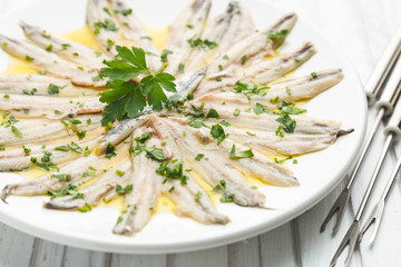 Marinated anchovies with olive oil and parsley