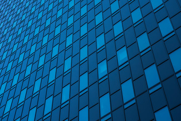 blue glass wall of a skyscraper
