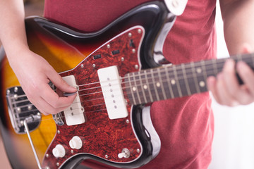 Playing a Fender Jazzmaster electric guitar