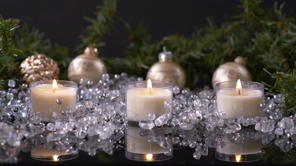 3 Candles Lit on Christmas Background