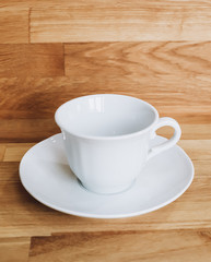 white cup on wooden table