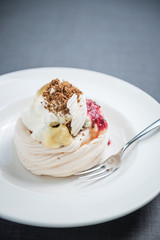 Pavlova cake with berries, vanilla, chocolate