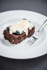 Chocolate brownie with berry sauce, blueberries