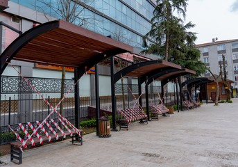 Fototapeta na wymiar empty public seats on local park parks forbidden to seat due to corona virus precautions