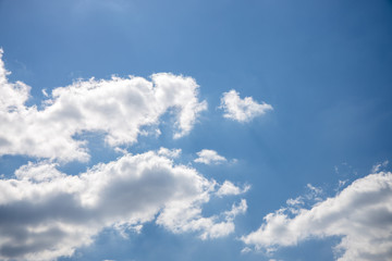 Naklejka na ściany i meble blue sky on a sunny warm day with white and gray clouds