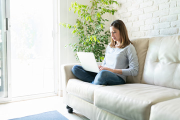 Fototapeta premium Pretty woman working from home with laptop