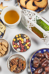 Iftar foods on white table. Traditional middle-eastern lunch with cookies and sweets