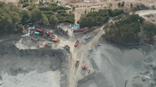 Panorama aerial view shot open pit mine breakstone, dumpers, quarrying extractive industry stripping work. Big Mining Trucks. View from drone at opencast mining. Economic crisis. Unemployment.
