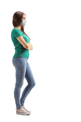 Young woman with a protective face mask waiting with crossed hands