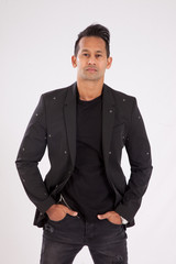 Fototapeta premium Handsome man in black shirt and jacket looking thoughtful