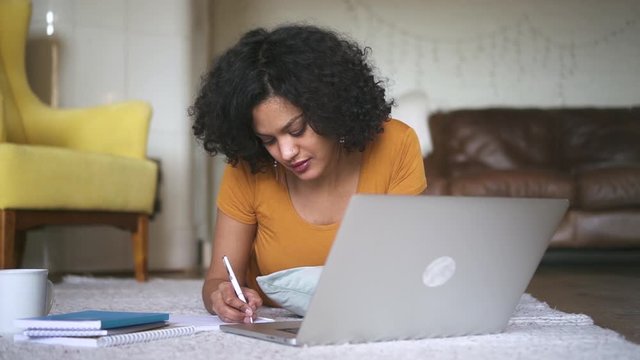 woman online studying writing homework in notebook looking at laptop Spbd. internet self education, e-learning, distant learning. concept isolation, quarantine, business