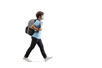 Schoolboy wearing a protective medical mask and walking