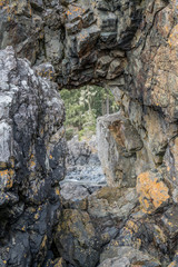 Fototapeta na wymiar Vertical rock arch window opening in Canada northwest