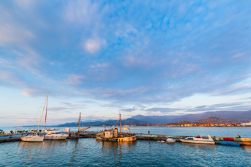 Beautiful sunset and small ships in Batumi sea port